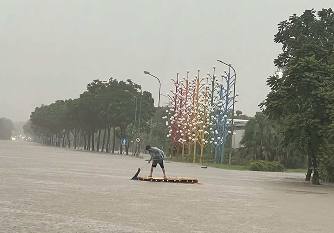 Tai Khu vuc Dai lo Thang Long, nguoi dan dung be tu che de di chuyen. Anh: Cuong Ngo