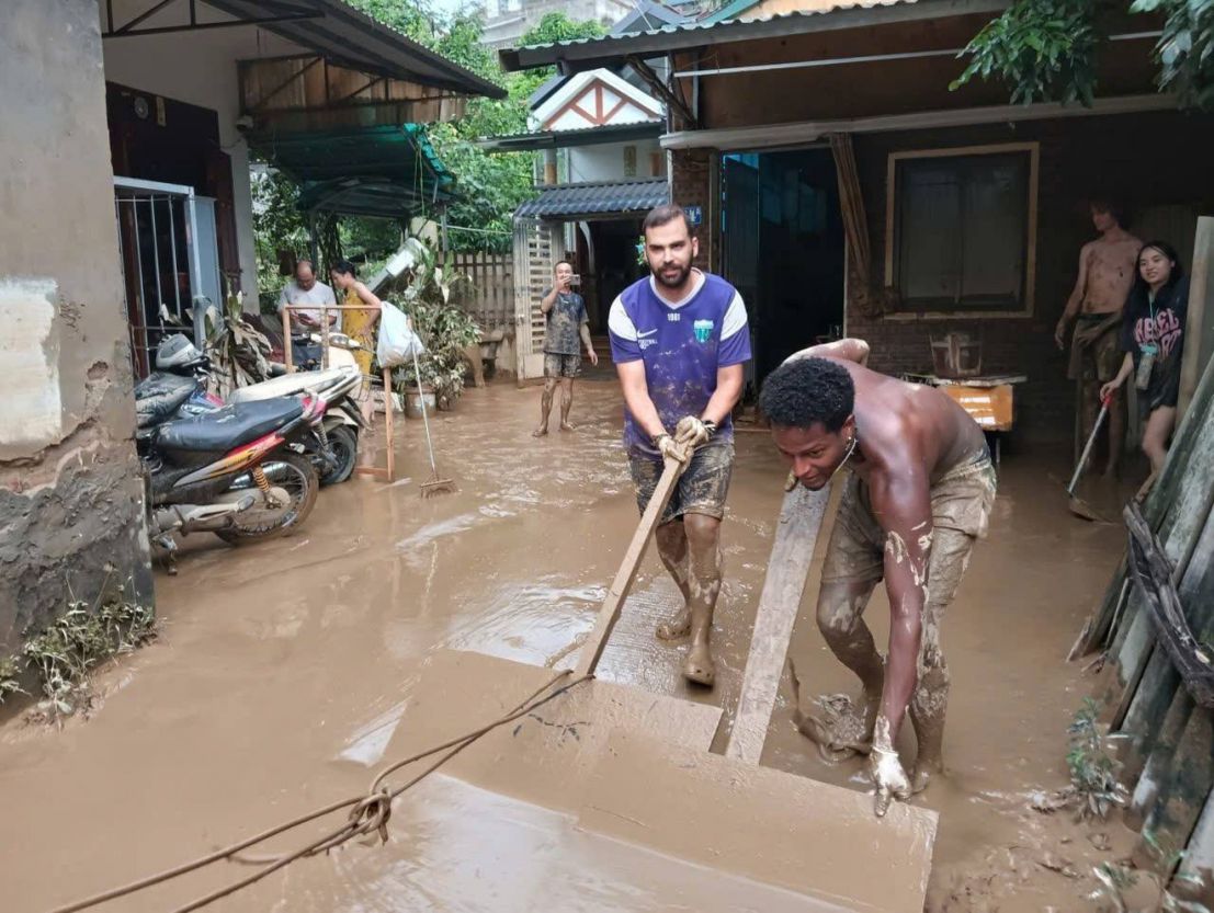 Western tourists joined hands to clean up mud after the flood with the locals. Photo: Character provided