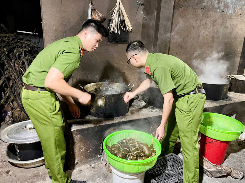 Luc luong CSGT cung hang chuc nguoi dan cung nhau goi banh chung tung ban tay thoan thoat, tung nam nep, mieng thit, la dong duoc xep ngay ngan de chuyen di Thai Nguyen