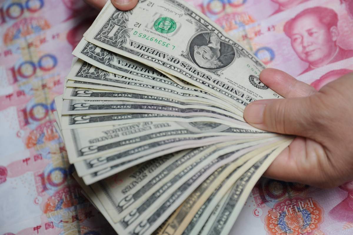 USD and yuan. Photo: Xinhua