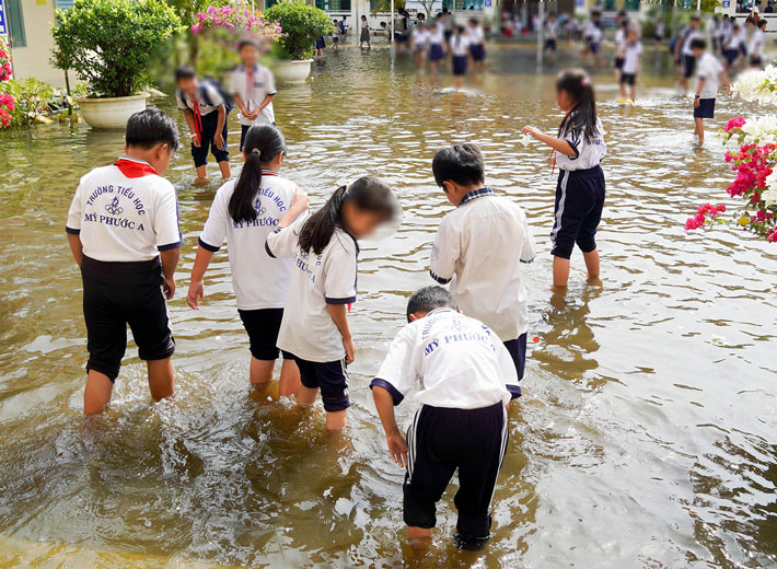 The schoolyard of My Phuoc A Primary School has been flooded for more than a month now. Photo: Phuong Anh