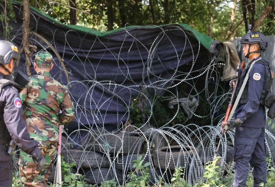 Cambodian soldiers stand guard near a barbed wire and tire fence deployed by Thai forces in Banteay Meanchey province, August 14, 2025. Photo: Xinhua