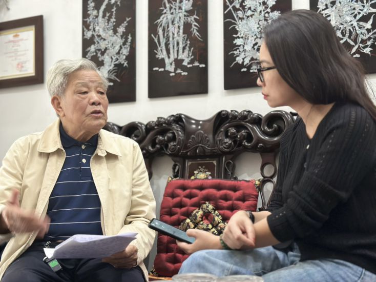 El Sr. Nguyen Tuc - Miembro de la Delegacion Presidente del Consejo Asesor de Cultura y Asuntos Sociales del Comite Central del Frente de la Patria de Vietnam intercambia opiniones con el periodista de Lao Dong. Foto: Quynh Chi