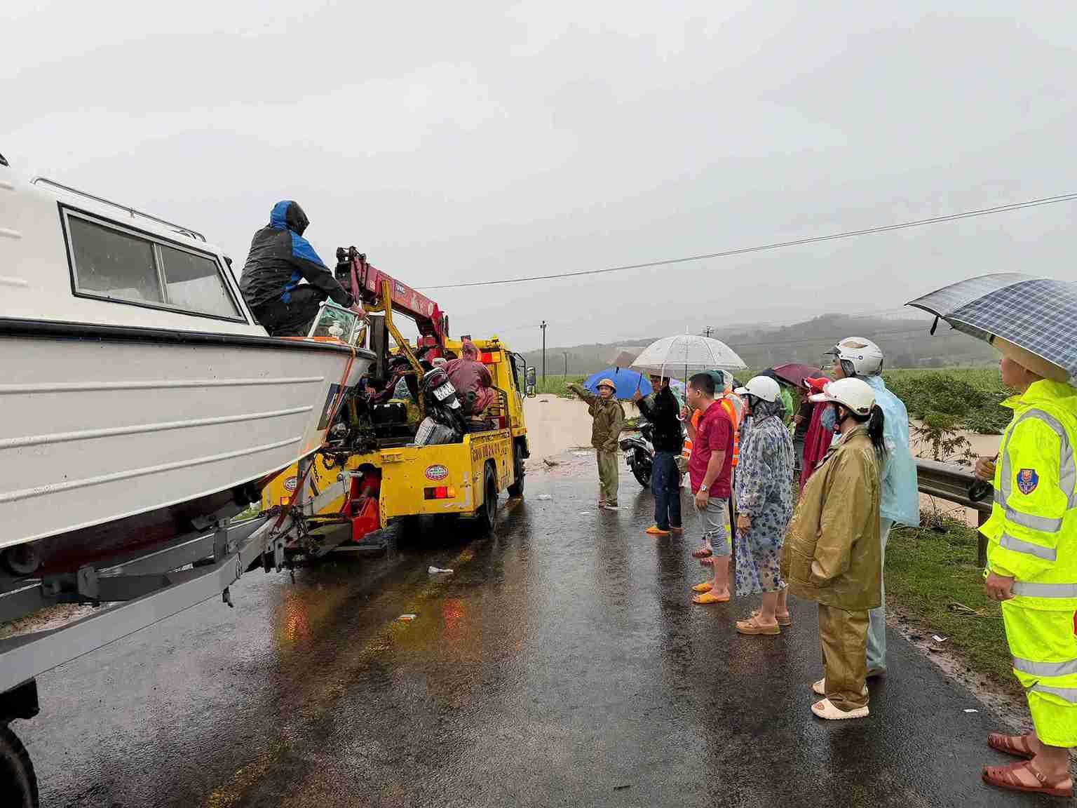 Luc luong chuc nang ho tro nguoi dan luu thong qua vung lu o khu vuc phia Dong tinh Dak Lak. Anh: Cong an cung cap