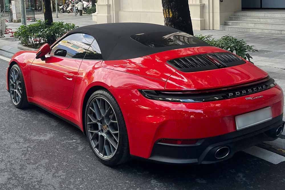 El Porsche 911 Cabriolet 992 rojo destaca en las calles de Hanoi con un techo de tela negra y llantas de doble embrague. Foto: Tuan Kiet