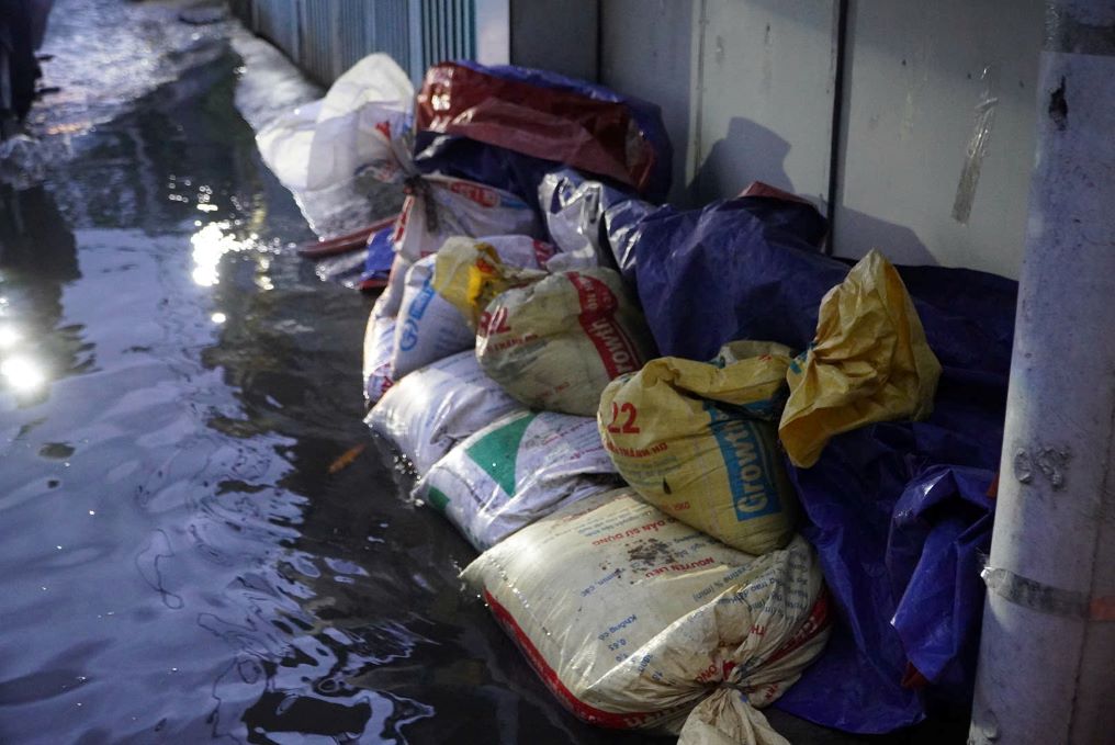 Nhieu ho dan phai dung van, bao cat... dap thanh de truoc cua nha de ngan nuoc tran vao. Anh: Nguyen Chan