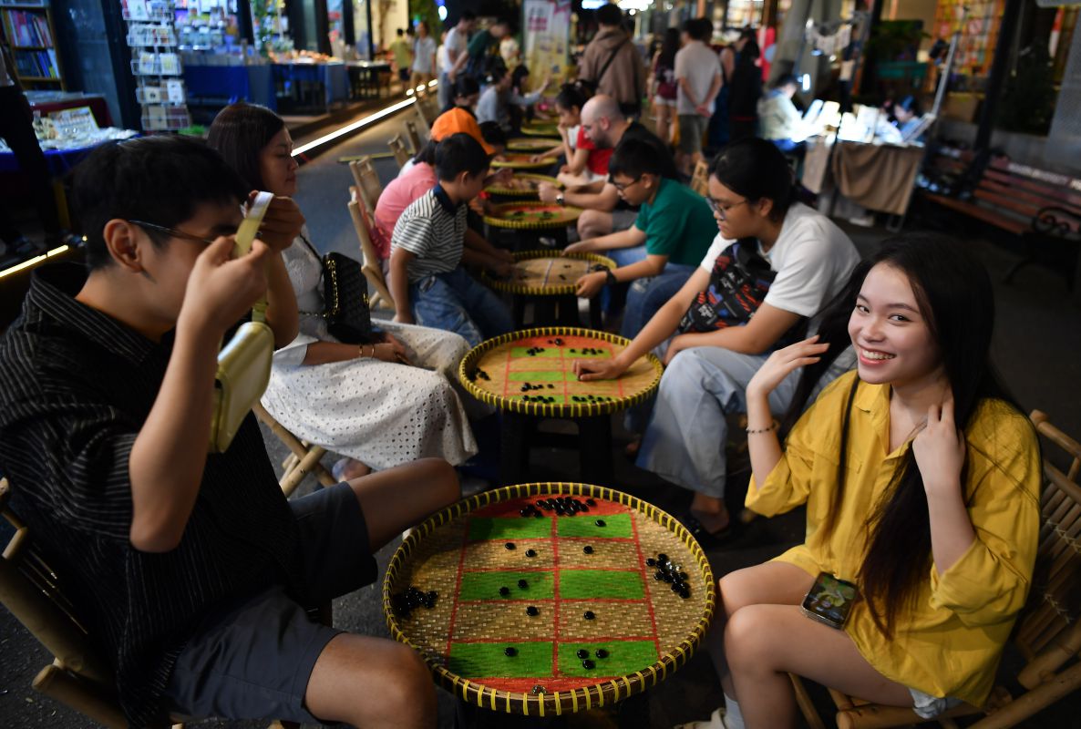 Nu cuoi co gai tre dang choi “O an quan“. Anh: Viet Van