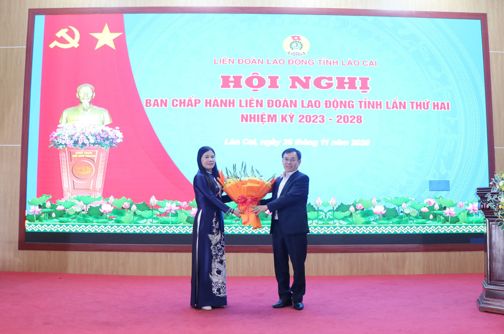 Truong Ban to chuc Tinh uy Pham Toan Thang tang hoa chuc mung tan Chu tich Lien doan Lao dong tinh Lao Cai. Anh: Bao Nguyen