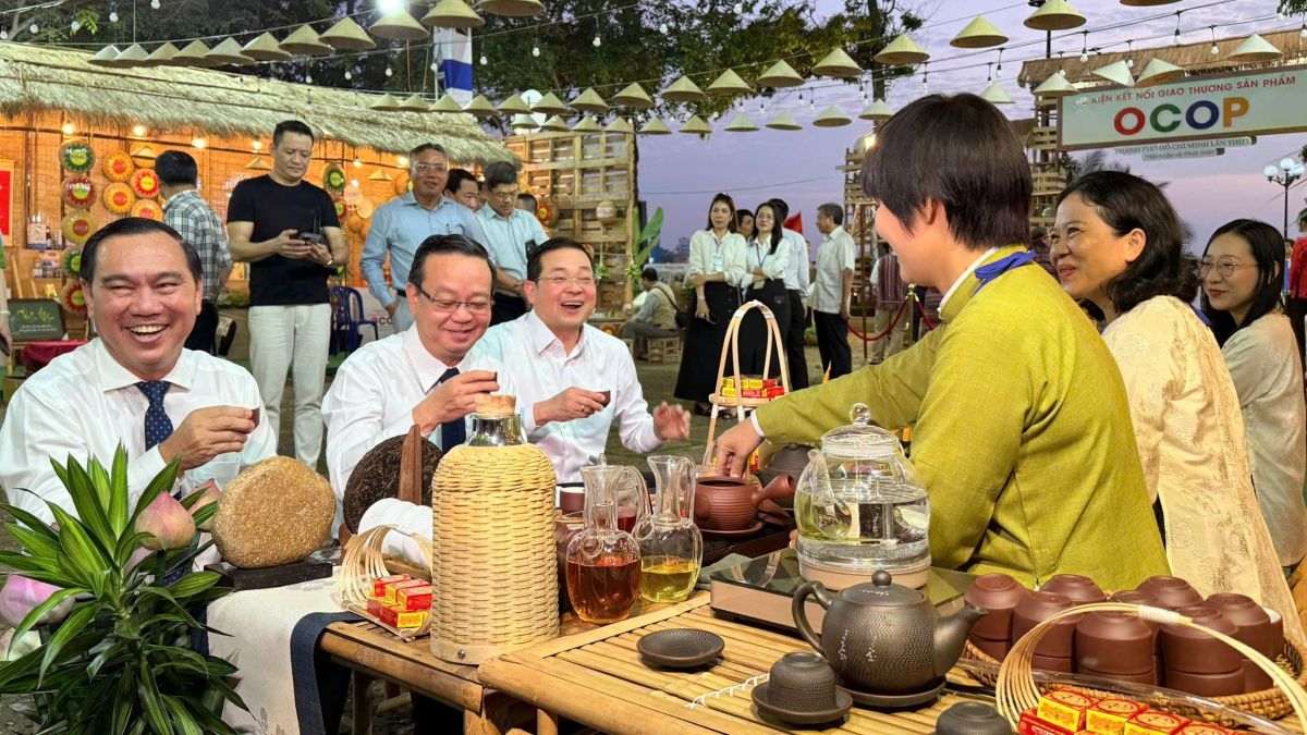 Lanh dao TPHCM tham quan cac gian hang, dung thu tra tai mot diem trung bay san pham. Anh: Thanh An