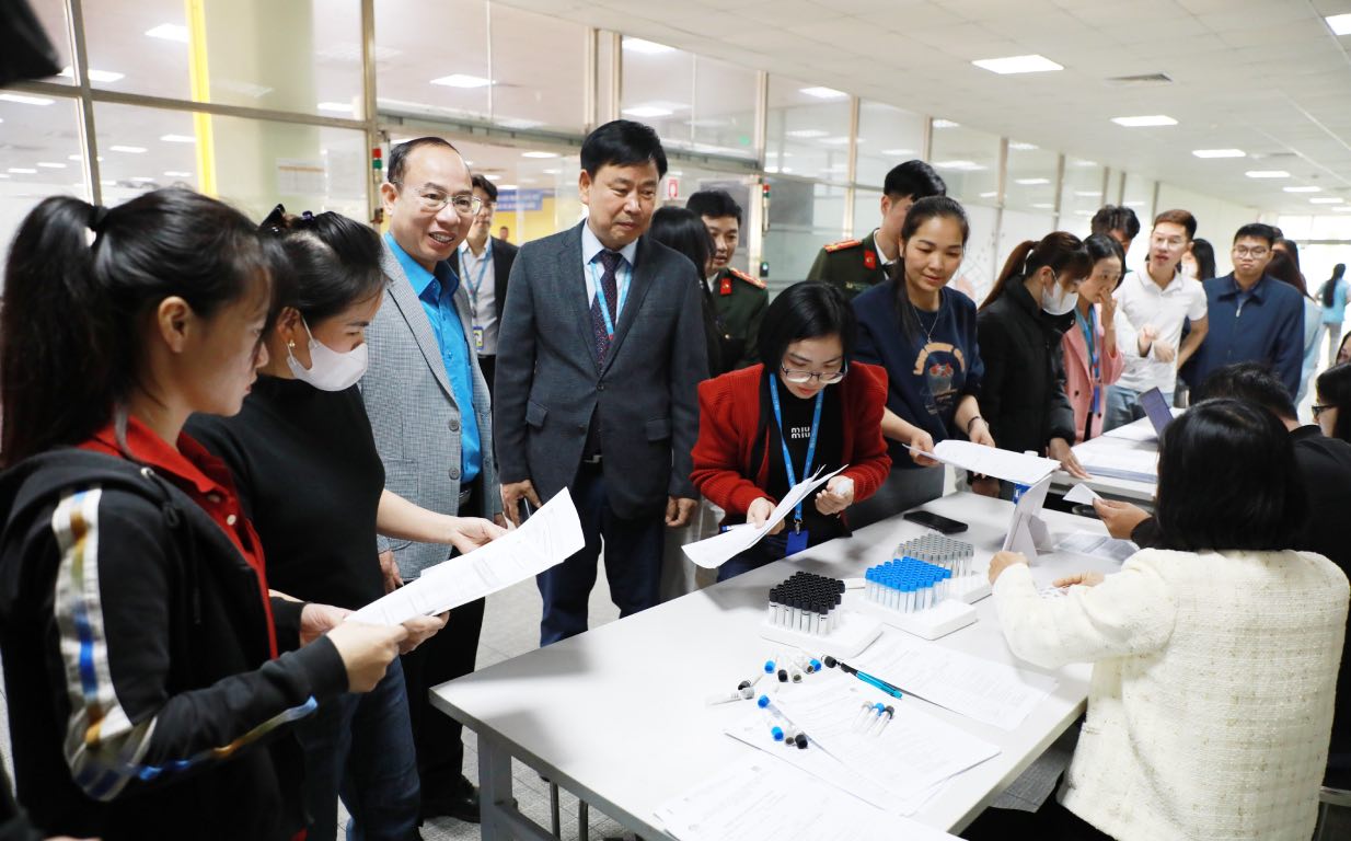 Los camaradas lideres visitan a miembros del sindicato y trabajadores en el programa. Foto: Quyet Chien