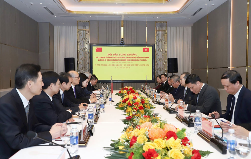 Hoi dam giua dong chi Nguyen Van Quang, Uy vien Ban Chap hanh Trung uong Dang Cong san Viet Nam, Chanh an Toa an nhan dan toi cao Viet Nam va dong chi Truong Quan, Uy vien Ban chap hanh Trung uong Dang Cong san Trung Quoc, Dai Tham phan thu nhat, Chanh an Toa an nhan dan toi cao Trung Quoc. Anh: Bao Cong ly