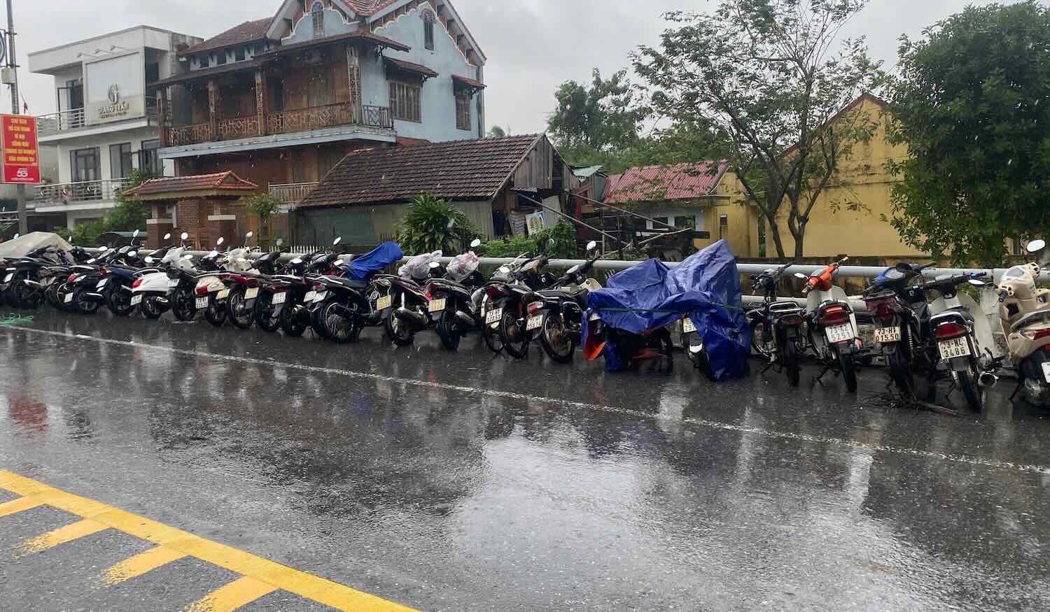 People brought motorbikes to the bridge to avoid flooding. Photo: Thai Ngoc