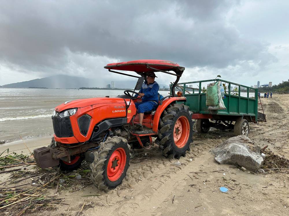 Cong nhan moi truong khan truong don dep bo bien. Anh: Thanh Huyen