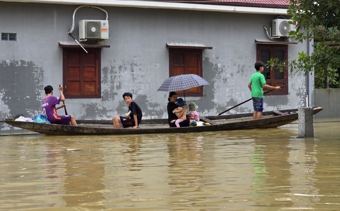 People in the flood-prone area of Nam Hai Lang travel by boat in flooded residential areas. Photo: Hung Tho