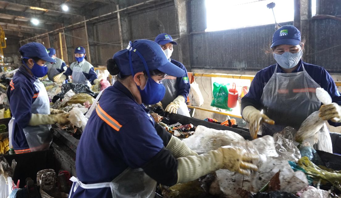 Cong nhan Lam Thi Nga (bia phai) truc tiep phan loai rac thai tai bang chuyen Xuong Phan loai, Xi nghiep Lien hop chat thai ran Soc Trang. Anh: Phuong Anh