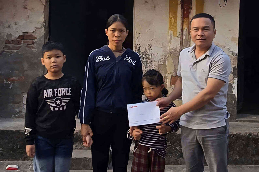 ラオドン新聞の記者がファム・ヴァン・サンさんの家族を支援するために読者にお金を寄付。写真: デュー・アン