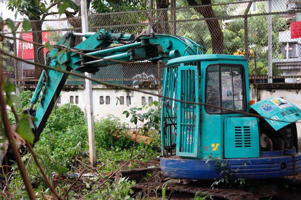 Cong nhan su dung xe xuc mini don co dai, phat quang cay ram, thu gom rac chuan bi mat bang. Ảnh: Thai Bao