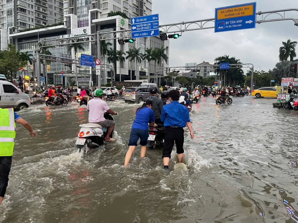 u co mat cua cac doan vien tai cac diem ngap khong chi giup giao thong thong suot ma con tao cam giac an tam cho nguoi dan khi di lai trong dieu kien thoi tiet bat loi. Anh: Thai Bao.