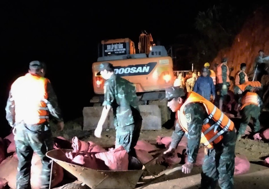 数百人の将校、兵士、ラムドン警察が徹夜でケイアン灌漑ダムの本体を補強した。写真: ハイズオン