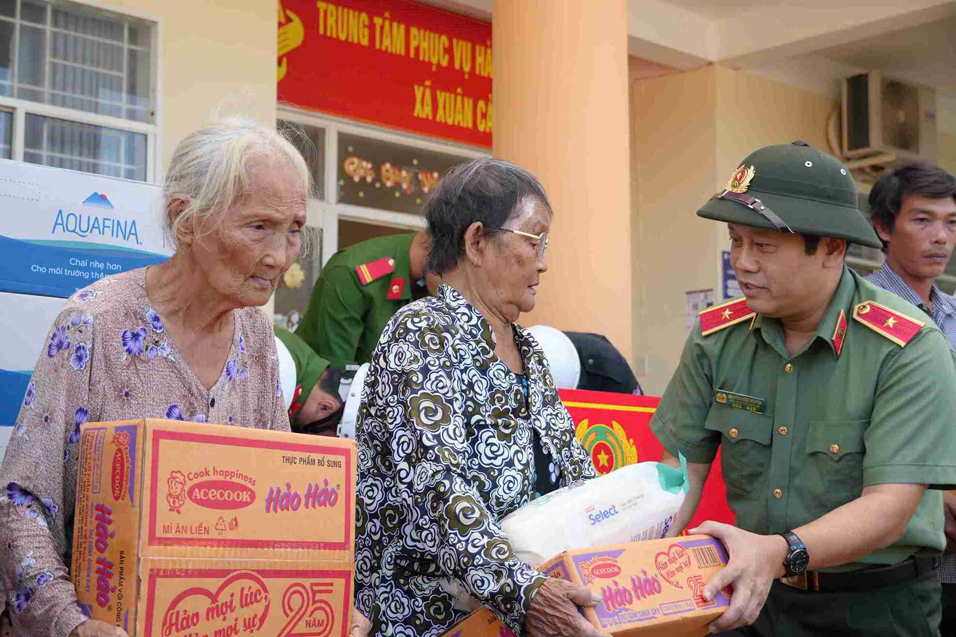 Thieu tuong Nguyen Hong Nguyen trao tan tay nguoi dan cac suat qua. Anh: Cong an cung cap