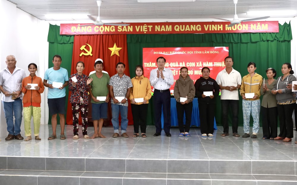 Ong Phan Dinh Trac - Uy vien Bo Chinh tri, Bi thu Trung uong Dang, Truong Ban Noi chinh Trung uong tang qua cho nguoi dan xa Ham Thuan bi thiet hai nang do mua lu. Anh: Duy Tuan