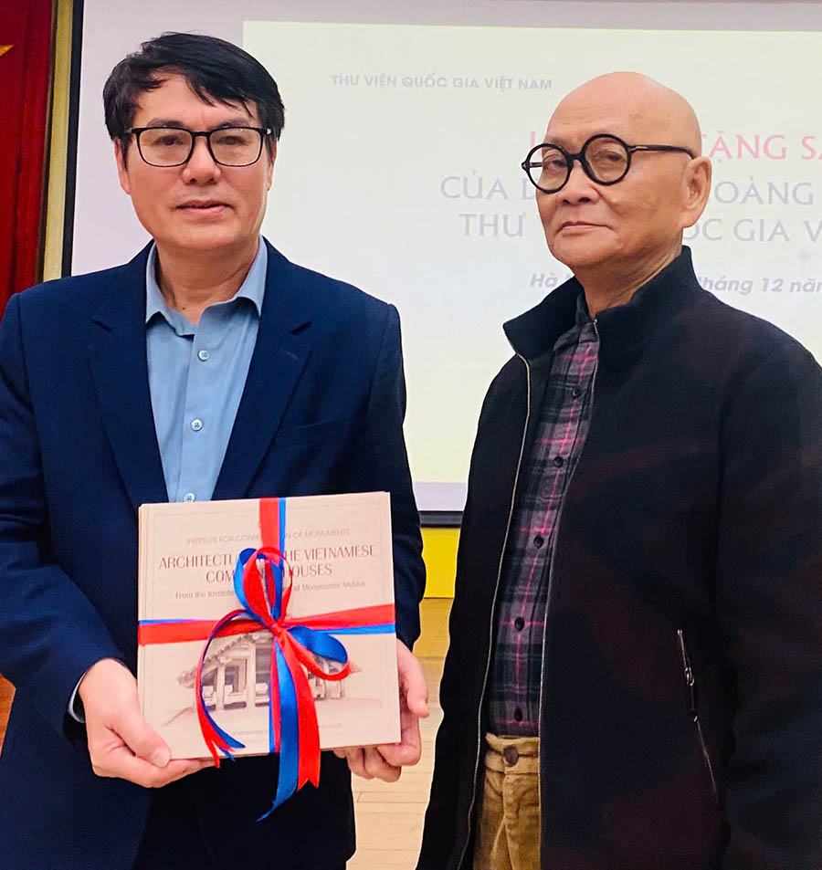 GS.TS.KTS Hoang Dao Kinh (phai) tang sach cho Giam doc thu vien Quoc gia Viet Nam - ong Nguyen Xuan Dung. Anh: Mi Lan