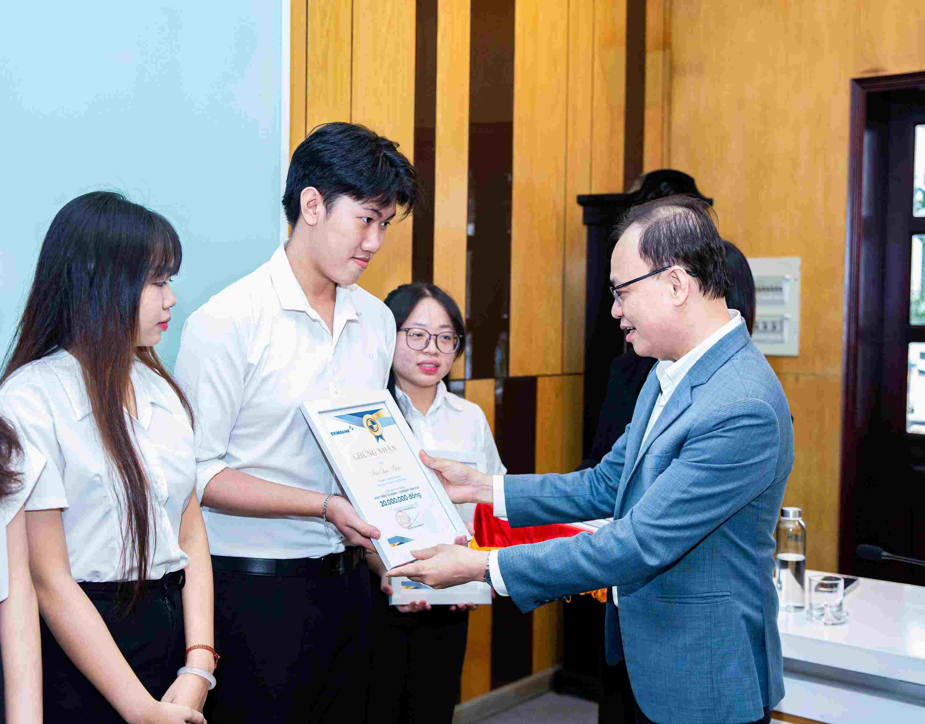Ong Nguyen Ho Hoang Vu – Pho Tong Giam doc Eximbank trao hoc bong cho sinh vien UEH trong chuong trinh “Eximbank – Phat trien tai nang nam 2025”. Anh: Eximbank