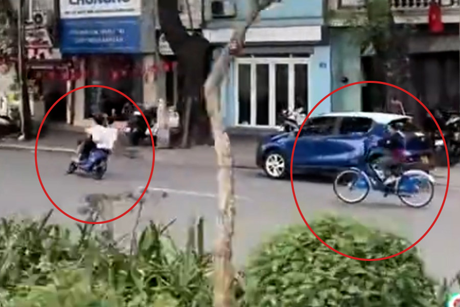 A group of teenagers driving electric bicycles weaving on the road. Photo cut from clip