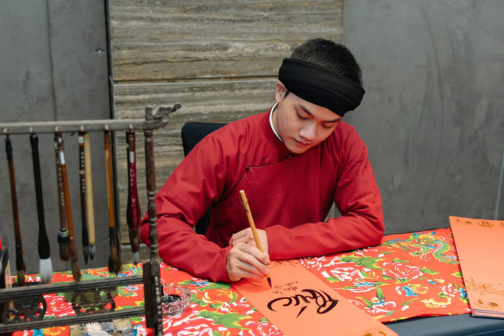 Mr. Bui Khac Sang (left) spreads traditional calligraphy art. Photo: NVCC