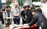Western tourists enjoy watching Dong Ho paintings at the circus