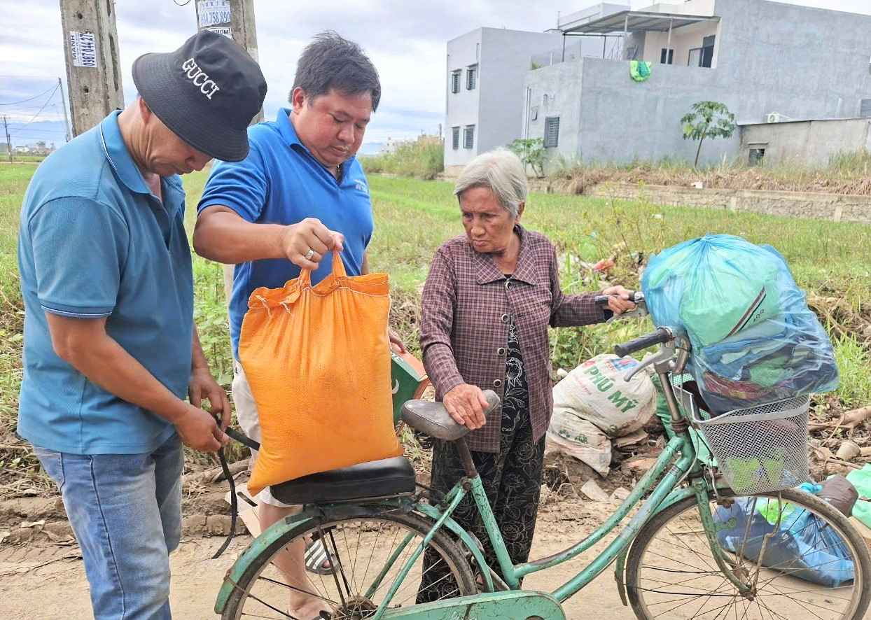 Doan vien Cong doan giao vien Trung tam Dao tao va Sat hach lai xe Ba Thien trao tang qua cho nguoi dan vung lu xa Phu Hoa 1 (Dak Lak). Anh: Van Huu