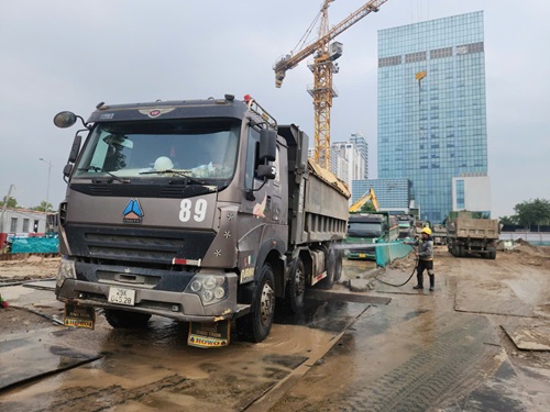 Truoc khi xe cho dat ra khoi cong truong deu duoc xit rua, nhung cung chi han che duoc dat cat theo xe ra ngoai moi truong. Anh: Minh Hanh 