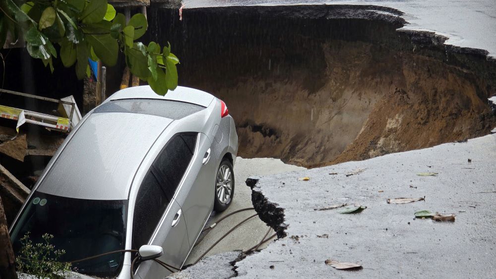 다낭 거리 한복판에서 '싱크홀'이 자동차를 삼키는 순간. 사진: Tran Thi