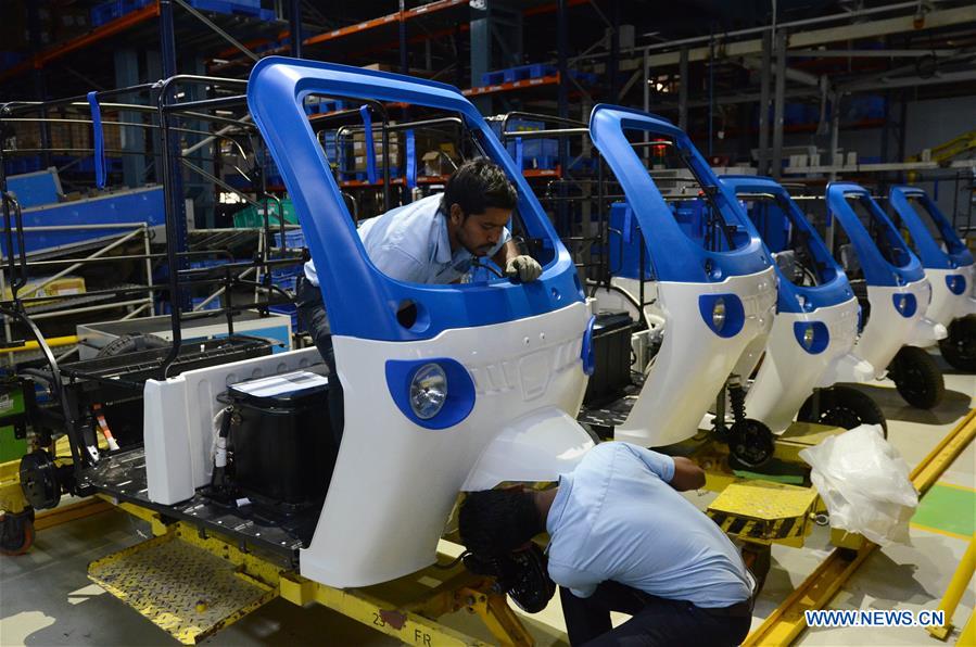 Assembling Mahindra Electric "suspended" three-wheeled electric vehicles in Bangalore, India. Photo: Xinhua