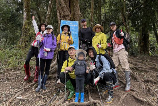 Members take photos with Ms. Ha's family during the trekking trip. Photo: Thanh Ha
