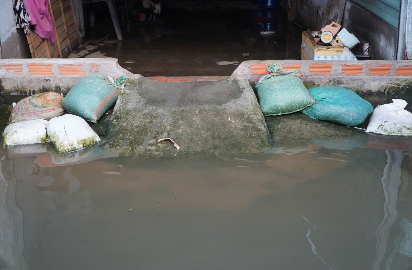 Nhung ho dan song ben duong Rach Cung luon chuan bi san bao cat de “dap de“, ngan nuoc tran vao nha.