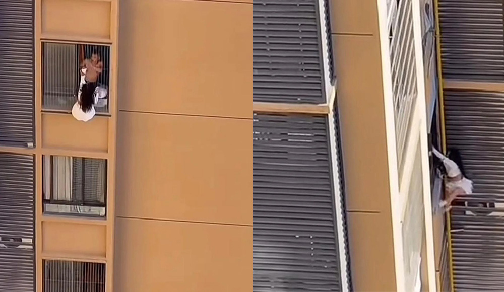 The moment the woman climbed out of the house of an bare, hanging on the 10th floor of an apartment building in China. Photo cut from video