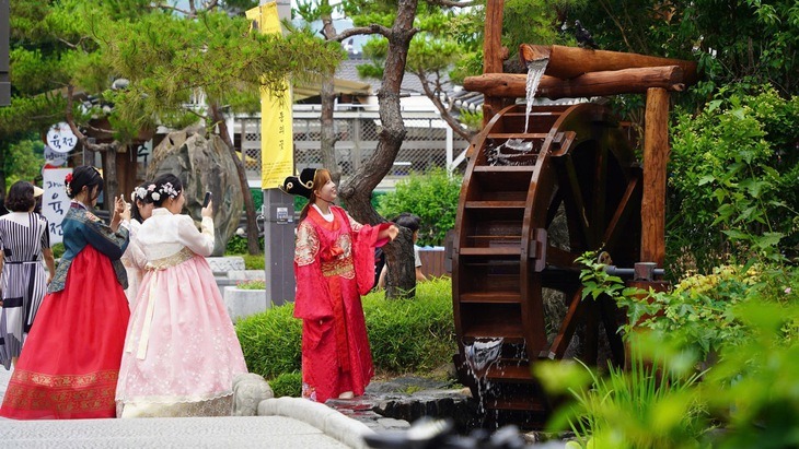 Tourists experience wearing hanbok, exploring traditional culture in Jeonju - the capital of Jeonbuk province, Korea.