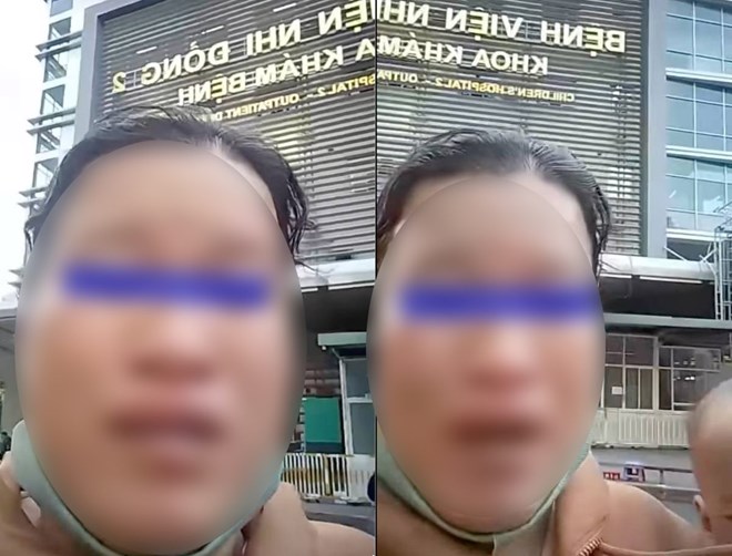 Photo cut from clip with information "woman holding child crying for help from online community in front of hospital gate" because of pickpocketing.