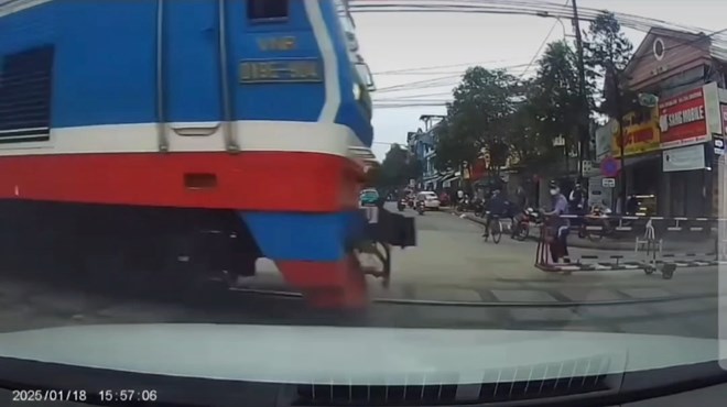 Photo cut from clip of train rushing in before the railway crossing gate was pulled back.