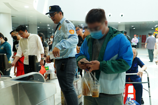 Mot hanh khach mang thuc uong khi di tau Metro da bi nhan vien bao ve nhac nho. 