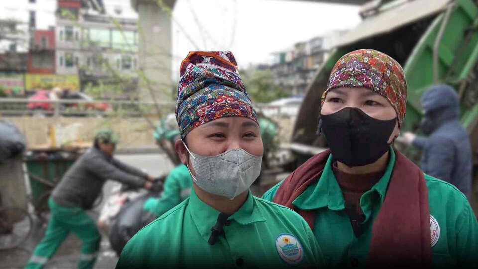 Environmental workers clean up the garbage after Tet