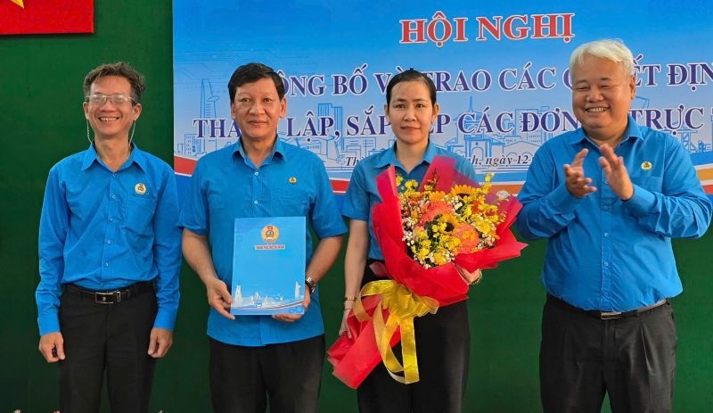 Mr. Vo Khac Thai - Chairman of the Ho Chi Minh City Labor Federation (right cover) presented the decision and congratulated the staff of the Organizing - Inspection Committee of the Ho Chi Minh City Labor Federation. Photo: Nam Duong