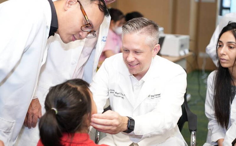 Dr. Runyan examines a disabled child before surgery. Photo: Provided by Nuoy