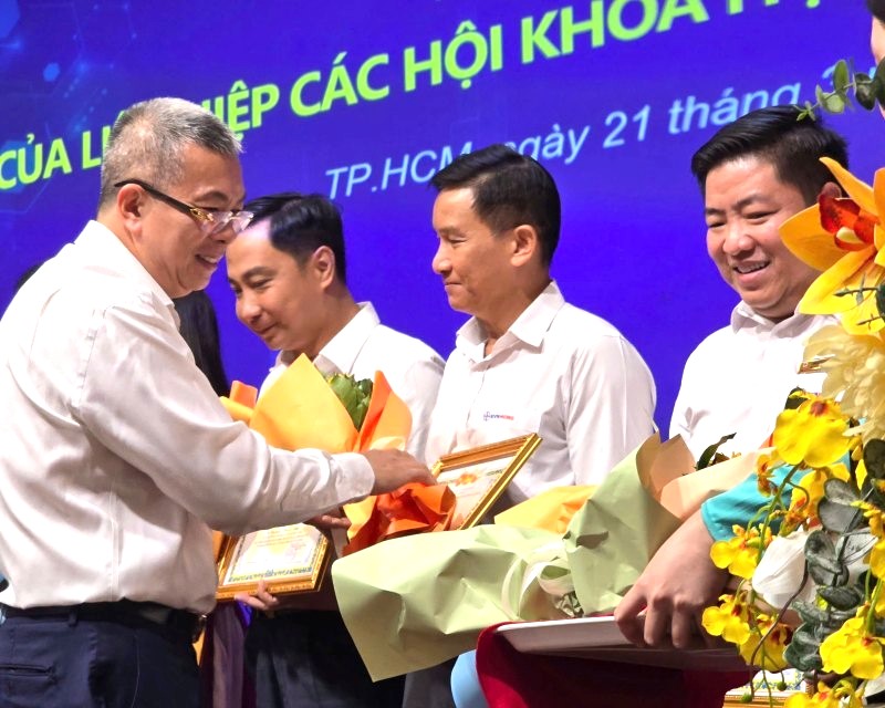 Ông Nguyễn Văn Thanh - Tổng giám đốc EVNHCMC - tặng hoa chúc mừng các tập thể, cá nhân có nhiều thành tích trong ứng dụng khoa học công nghệ, đổi mới sáng tạo và chuyển đổi số. Ảnh: Nam Dương