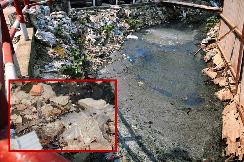 The ditch is covered with black water, making Hanoians bored