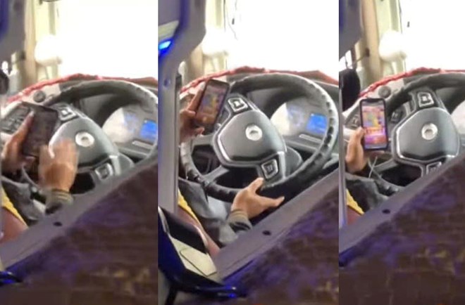 The image cut from the clip recorded driver D driving a passenger car while playing a game.