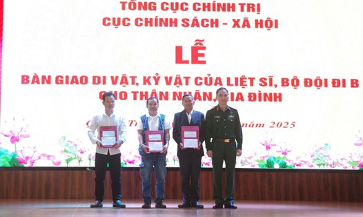 Đại diện Cục Chính sách - Xã hội, Tổng Cục Chính trị bàn giao di vật, kỷ vật của liệt sĩ cho thân nhân các liệt sĩ. Ảnh: Xuân Diện