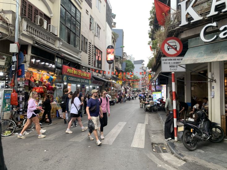 International visitors traveling on Dinh Liet Street. Photo: Y Yen