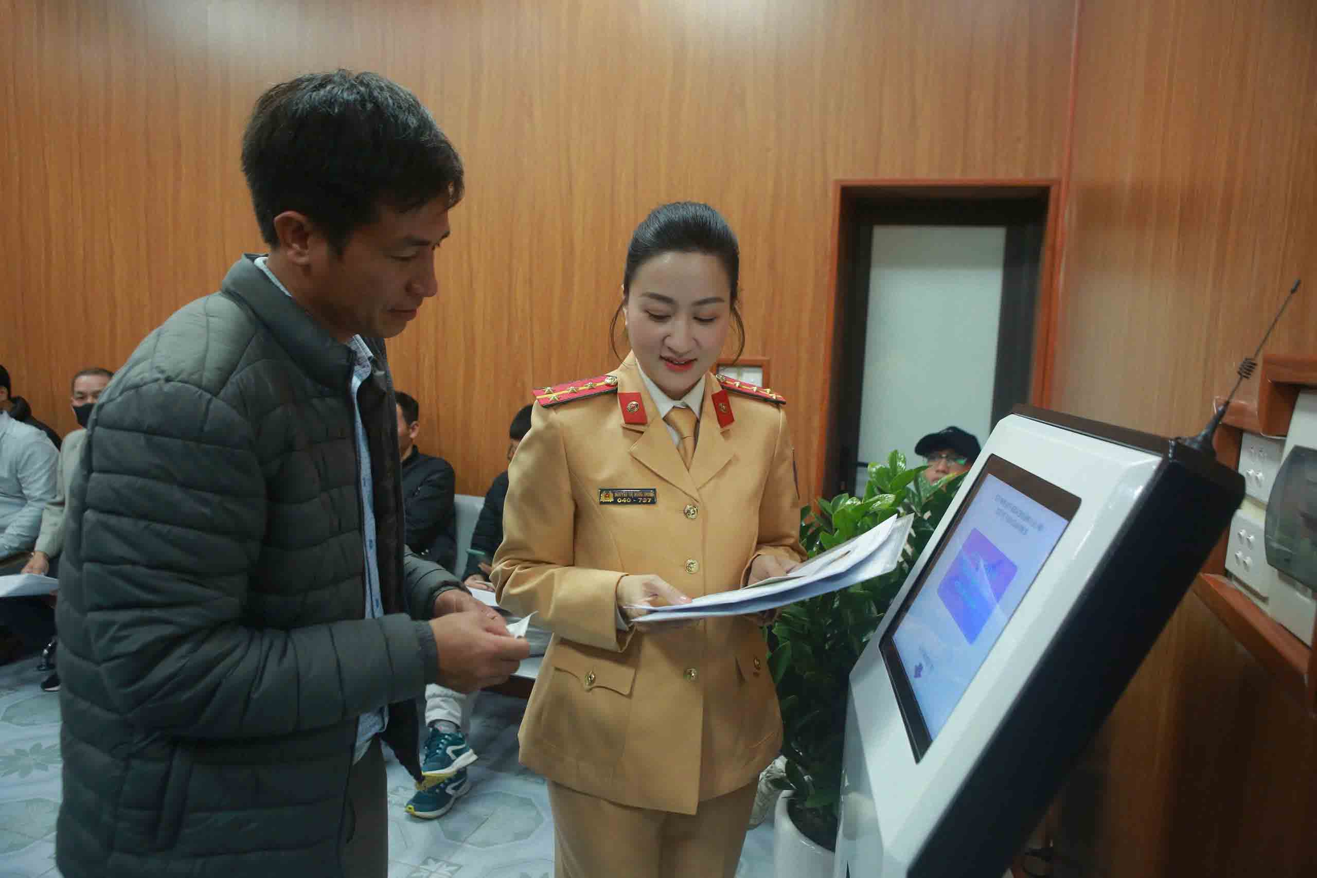 Traffic Police officers (Hanoi City Police) guide people through procedures for granting and exchanging driving licenses. Photo: Huu Chanh